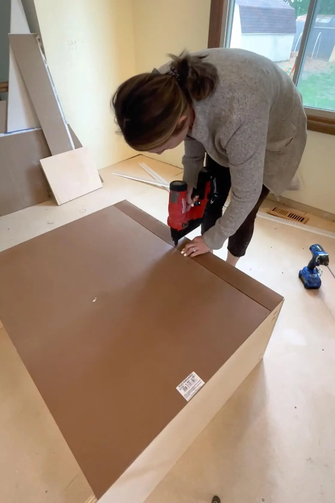 Adding a backing to pantry shelves.